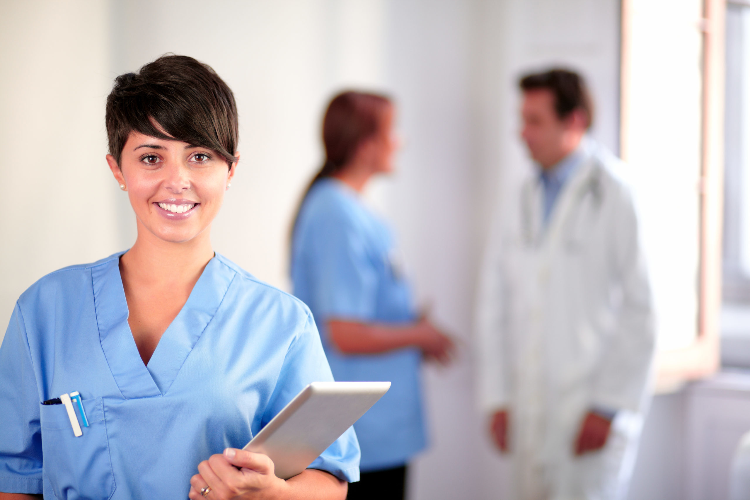 Lovely latin nurse on blue uniform standing