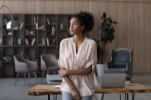 young female contemplating looking out of window